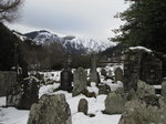 SX02677 Snow on tomb stones in Glendalough with view to Lugduff mountain.jpg